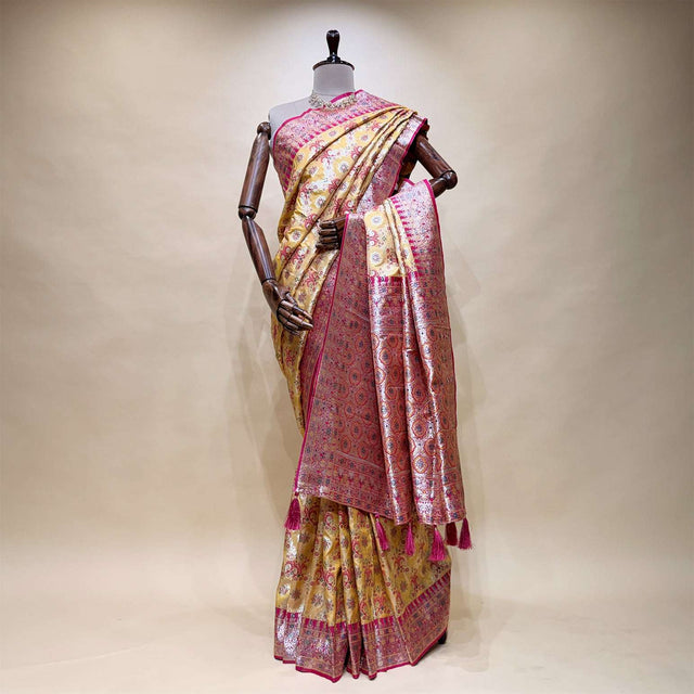 Pink silk saree with geometric motifs, contrast border pallu and tasselled hem