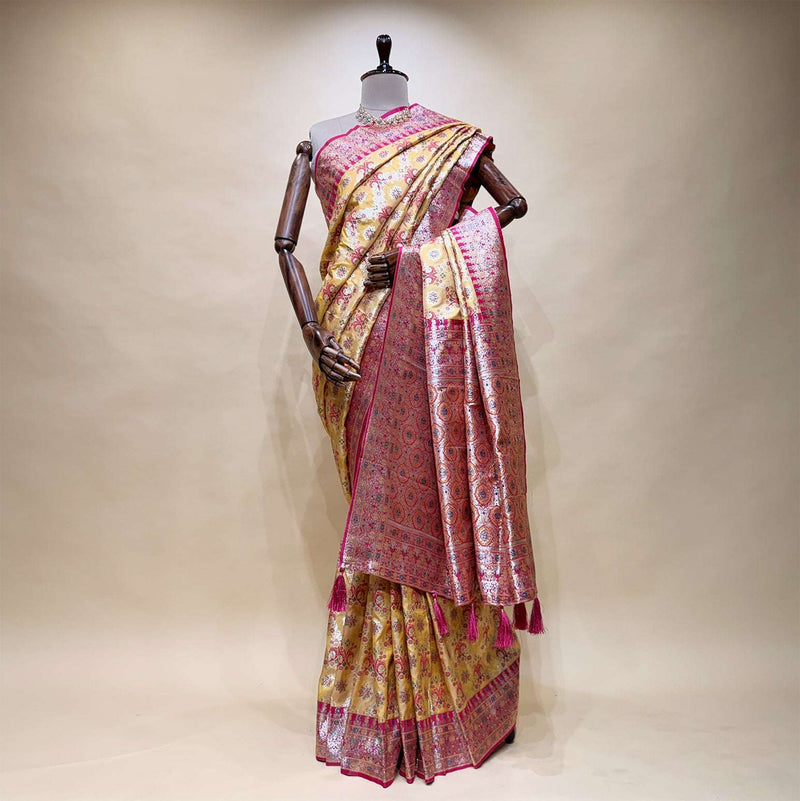Pink silk saree with geometric motifs, contrast border pallu and tasselled hem