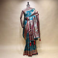 Turquoise silk saree with geometric motifs and contrast silver border pallu