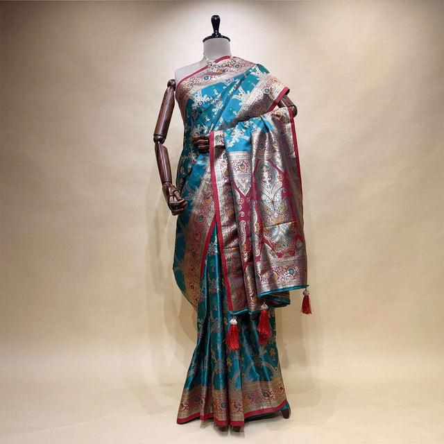 Turquoise silk saree with geometric motifs and contrast silver border pallu
