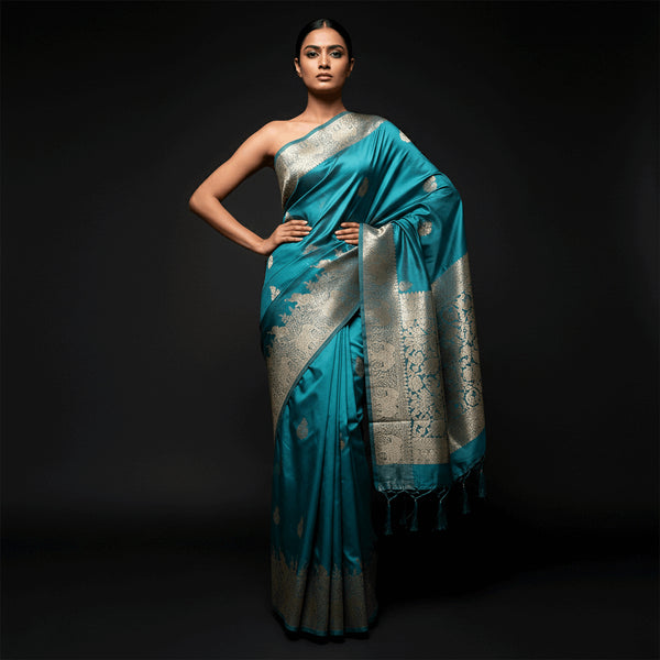Teal satin silk saree with silver zari elephant motifs and wide woven border