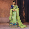 Banarasi silk lehenga set in green with blue blouse and matching dupatta