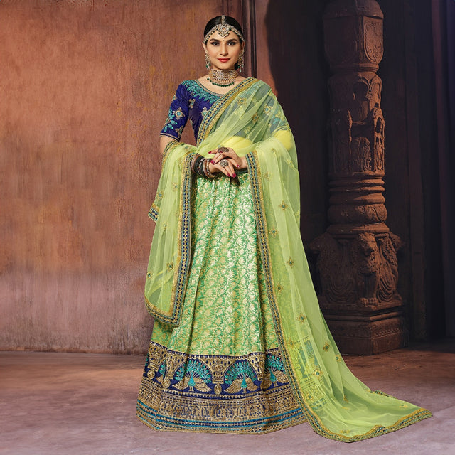 Banarasi silk lehenga set in green with blue blouse and matching dupatta