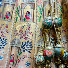 Embroidered lehenga fabric detail with gold threads, floral motifs and tassel trim