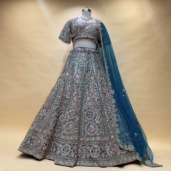 Peacock teal lehenga with silver, pink and zari-style embroidery, full skirt flare