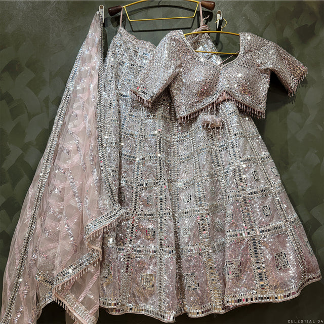 Champagne rose mirror-work lehenga and blouse set on hangers, silver beaded detailing