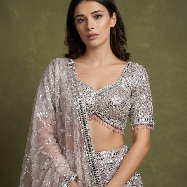 Champagne rose mirror-work blouse with deep V neckline and net dupatta, silver beads