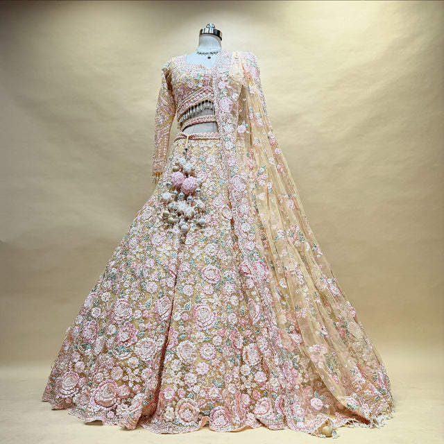Pastel embroidered lehenga with ornate floral motifs, fitted blouse, and flowing net dupatta
