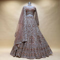 Dusty mauve bridal lehenga with silver zari embroidery, beaded motifs, net dupatta