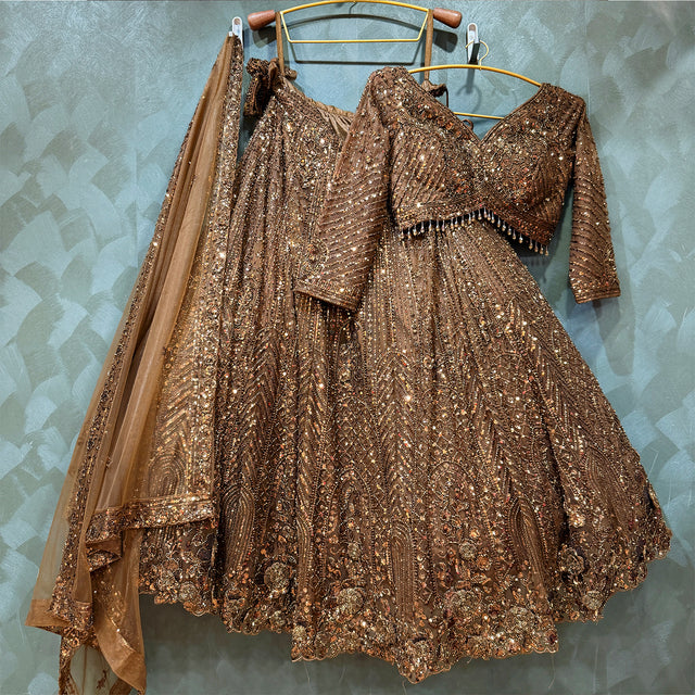 Sequin-embroidered golden lehenga with matching blouse and draped dupatta set