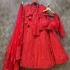 Red sequin lehenga set on hangers: blouse, skirt, and sheer dupatta