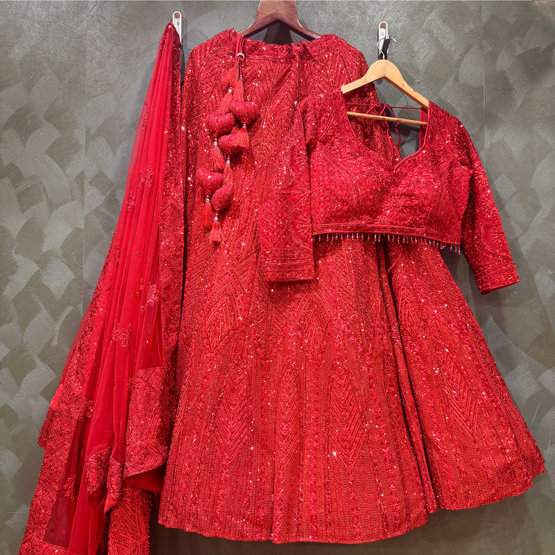 Red sequin lehenga set on hangers: blouse, skirt, and sheer dupatta