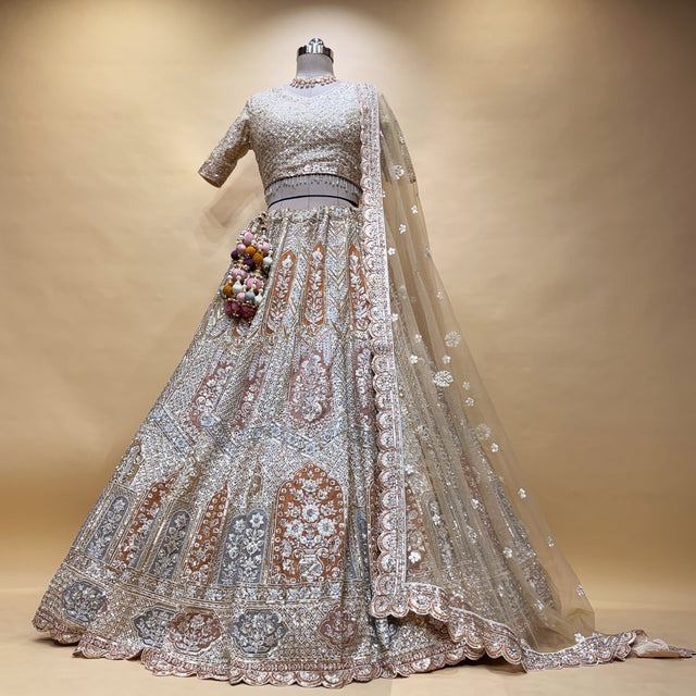 Ivory bridal lehenga with long flared skirt, sequin blouse, and sheer embroidered dupatta