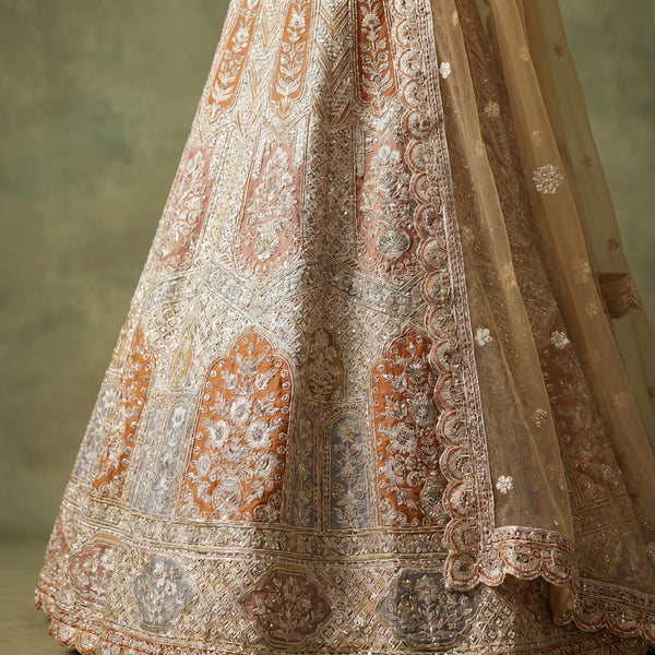 Ivory bridal lehenga with ornate zari embroidery, sequin work, and decorative border