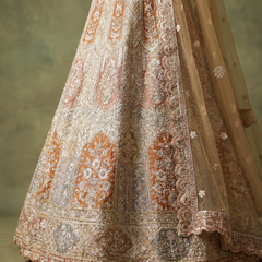Ivory lehenga skirt close-up with detailed embroidery panels and scalloped border hem