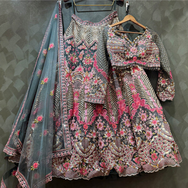 Embroidered lehenga and choli on hangers, floral patterns, gray-blue dupatta