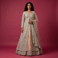 Silver net bridal gown lehenga with peach base, long sleeves, V-neck and scalloped hem