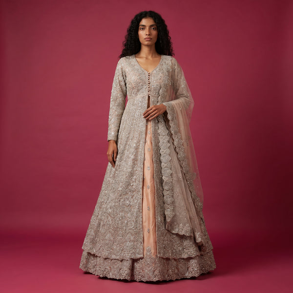 Silver net bridal gown lehenga with peach base, long sleeves, V-neck and scalloped hem