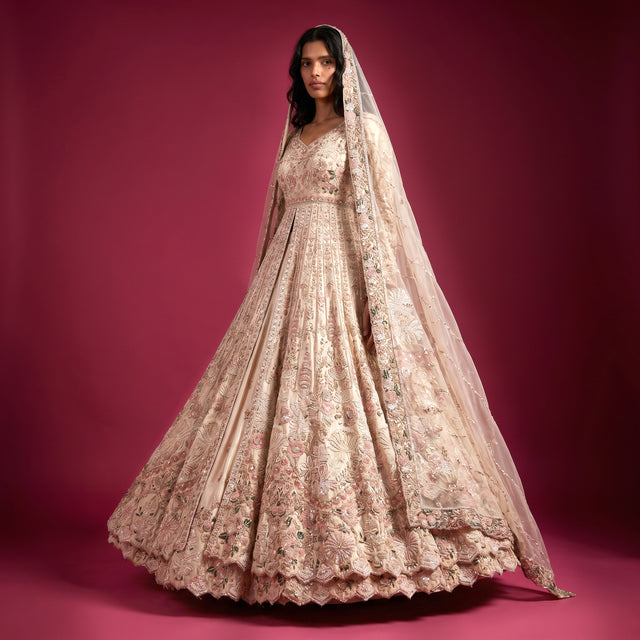 Ivory shimmer bridal reception gown with beaded bodice, puff skirt, and veil