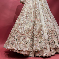 Ivory shimmer bridal reception gown with ornate pearl beaded embroidery and full skirt