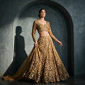 Antique gold sequin and stone work floral lehenga with full-sleeve blouse and net dupatta, worn