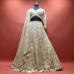 Ivory net cutdana lehenga set with beaded-fringe blouse and net dupatta on mannequin
