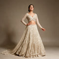 Ivory net cutdana handwork lehenga with wrap blouse and heavy net dupatta with train, worn