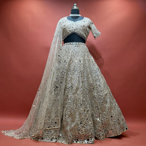 Champagne mirror work lehenga set with blouse and net dupatta on mannequin