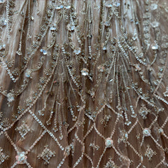 Close-up of champagne gold sequin lattice, beaded stems and sequin flowers on a crinkled shimmer base