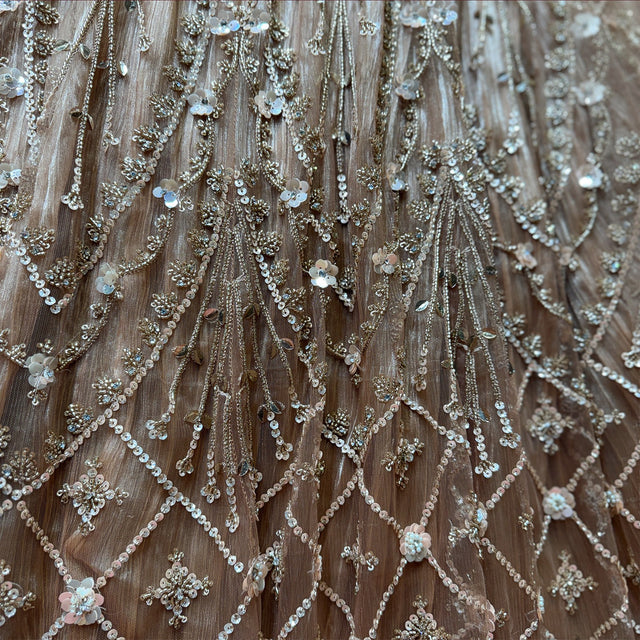 Close-up of champagne gold sequin lattice, beaded stems and sequin flowers on a crinkled shimmer base