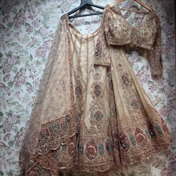 Ivory embellished lehenga and matching dupatta on hangers