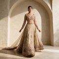 Ivory net lehenga with beaded panels, medallion border, full-sleeve handwork blouse and heavy net dupatta