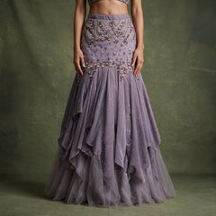 Close-up of the mauve lavender fish cut skirt with a beaded chevron yoke, pearl flowers and handkerchief-edged sequin ruffle tiers