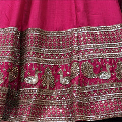 Rani pink lehenga waistband and hem with silver mirrorwork and embroidered motifs