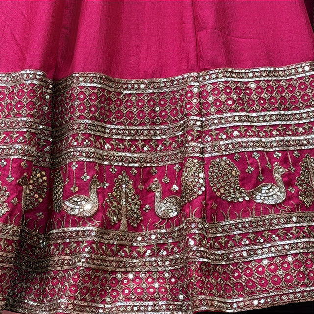 Rani pink lehenga waistband and hem with silver mirrorwork and embroidered motifs