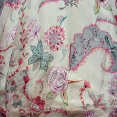Close-up of floral and feather-leaf print with butterflies and stone accents on off white silk
