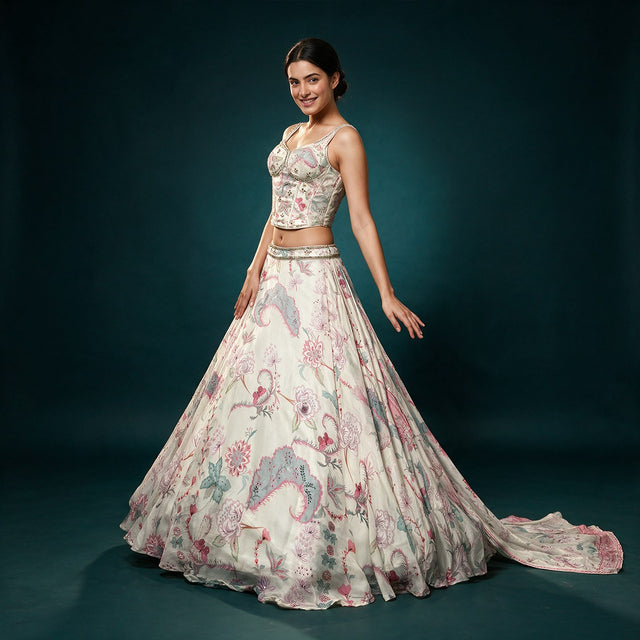 Off white silk floral print corset lehenga with beaded straps and trailing printed dupatta, worn