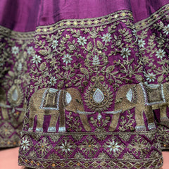Embroidered elephant motif detail on wine purple lehenga skirt hem border