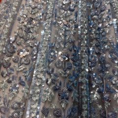 Close-up of blue and silver floral sequin embroidery on net