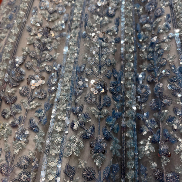 Close-up of blue and silver floral sequin embroidery on net