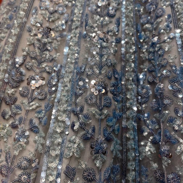 Close-up of blue and silver floral sequin embroidery on net