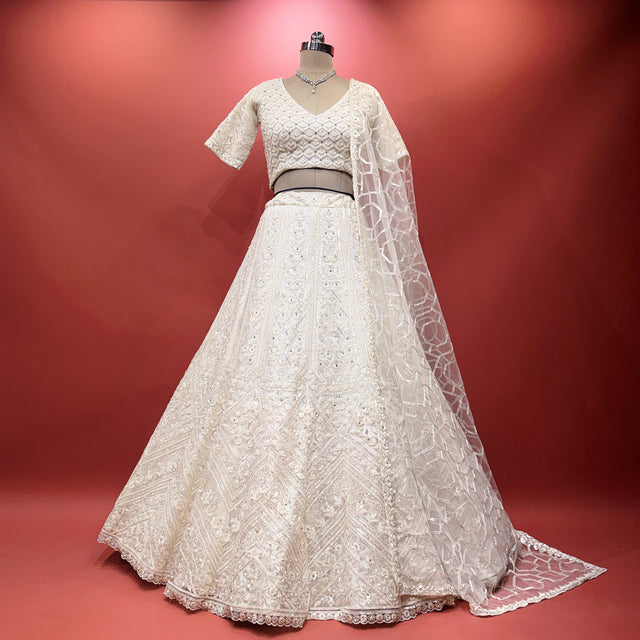 Off-white sequin net lehenga with short-sleeve blouse, flared skirt and dupatta