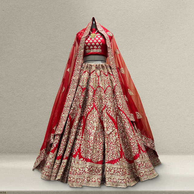 Red bridal lehenga with silver-gold embroidered panels and flared skirt hem