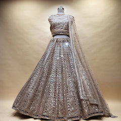 Ivory gold net mirror handwork lehenga on a mannequin with mirror columns, mirror blouse and net dupatta