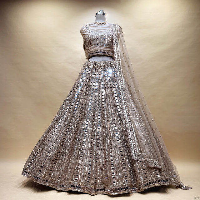 Embellished ivory and gold net lehenga dress with mirrored beadwork and flared skirt