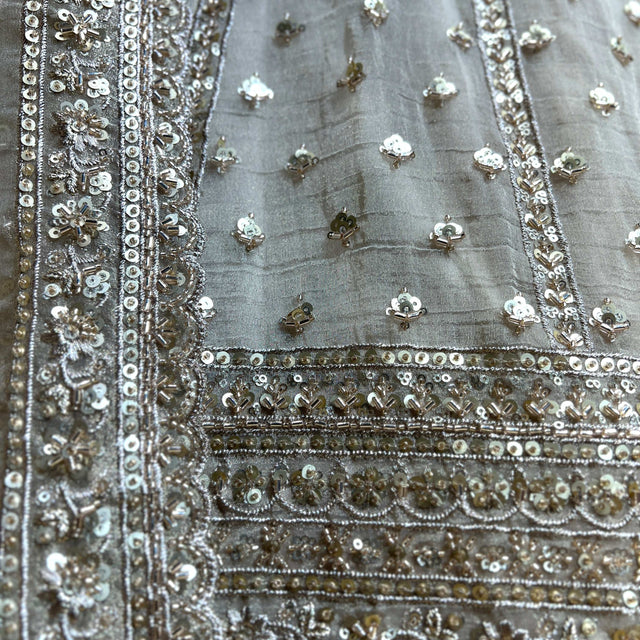 Beaded lehenga fabric with silver sequins, stones, and ornate border trim