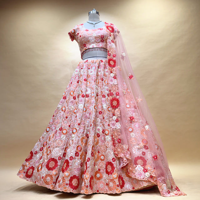 Blush pink lehenga with red multicolor floral 3D applique and embroidered skirt hem