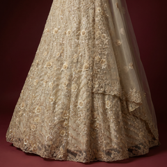 Ivory net floral lehenga skirt with 3D cutdana embellishment, flared hem
