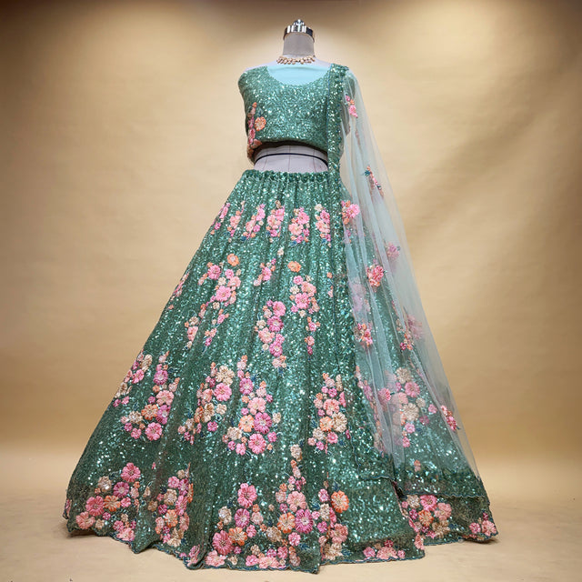 Teal green sequin lehenga set with pink floral motif skirt and sheer sleeves