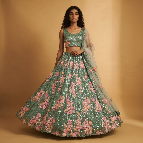 Teal green lehenga set with pink floral moti sequins and sheer dupatta